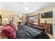 Bedroom with a large bed, ceiling fan, mirrored closet, and a private outdoor balcony at 2920 Poplar Ave, Leesburg, FL 34748