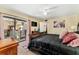 Bedroom with a large bed, ceiling fan, and a private outdoor balcony overlooking the complex at 2920 Poplar Ave, Leesburg, FL 34748