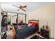 Spacious bedroom featuring a ceiling fan, mirrored closet doors, and a comfortable queen-sized bed at 2920 Poplar Ave, Leesburg, FL 34748