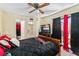 Comfortable bedroom featuring a ceiling fan, TV, and access to a private balcony at 2920 Poplar Ave, Leesburg, FL 34748