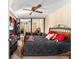 Spacious bedroom featuring a ceiling fan, mirrored closet doors, and a comfortable queen-sized bed at 2920 Poplar Ave, Leesburg, FL 34748