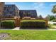 Charming townhome featuring unique roofline, private balcony, and well-maintained front yard with privacy fence at 2920 Poplar Ave, Leesburg, FL 34748