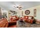 Welcoming living room featuring comfortable seating, a ceiling fan, and access to other areas of the home at 2920 Poplar Ave, Leesburg, FL 34748