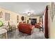 Comfortable living room with plush leather sofas, ceiling fan, stylish decor, and ample natural light at 2920 Poplar Ave, Leesburg, FL 34748