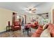 Bright living room with comfortable seating, a ceiling fan, and a sliding door offering backyard views at 2920 Poplar Ave, Leesburg, FL 34748