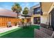 Inviting patio with outdoor seating, umbrella, and lush tropical landscaping at 2920 Poplar Ave, Leesburg, FL 34748