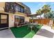 Inviting patio with outdoor seating, umbrella, and well-maintained artificial grass at 2920 Poplar Ave, Leesburg, FL 34748