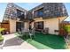 Inviting patio with outdoor seating, umbrella, and well-maintained artificial grass at 2920 Poplar Ave, Leesburg, FL 34748