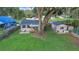 Aerial view of home with large, grassy yard, detached unit, patio and mature tree at 30523 Orange Dr, Leesburg, FL 34748