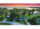 Charming home nestled among mature trees with lake views and vibrant sunset at 30523 Orange Dr, Leesburg, FL 34748