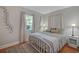 Bedroom featuring hardwood floors, neutral colors and ample natural light at 30523 Orange Dr, Leesburg, FL 34748