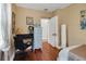 Bedroom includes hardwood floors, chair and desk at 30523 Orange Dr, Leesburg, FL 34748