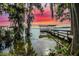 Scenic view of a wooden dock with a covered area, perfect for lake relaxation at 30523 Orange Dr, Leesburg, FL 34748