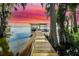 Picturesque dock with covered area and stunning lake views at sunset at 30523 Orange Dr, Leesburg, FL 34748