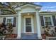 Welcoming front entrance features a covered porch with decorative columns and a stylish door at 30523 Orange Dr, Leesburg, FL 34748