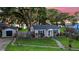 Charming home with manicured lawn, fenced yard, and detached garage at 30523 Orange Dr, Leesburg, FL 34748
