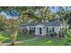 Charming single-story home with a well-maintained front yard and mature trees for shade at 30523 Orange Dr, Leesburg, FL 34748