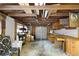 Inside the garage showcasing wood beams, concrete flooring, and a variety of workbenches at 30523 Orange Dr, Leesburg, FL 34748
