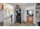 Kitchen includes stainless steel refrigerator, metal shelving and tile floor at 30523 Orange Dr, Leesburg, FL 34748