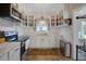 Bright kitchen featuring white cabinets, stainless steel appliances and decorative window treatments at 30523 Orange Dr, Leesburg, FL 34748