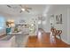 Living room with hardwood floors, area rug, ceiling fan and lots of natural light at 30523 Orange Dr, Leesburg, FL 34748