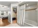 Bright bathroom features a shower with decorative curtain, as well as access to the main bedroom and a walk-in closet at 3184 Maltby Dr, Deltona, FL 32738