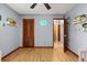 This empty bedroom features wood floors, grey walls, and a neon dinosaur decoration, ready for personalization at 3184 Maltby Dr, Deltona, FL 32738
