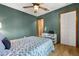 Green bedroom with wood floors features a queen bed and a closet for ample storage at 3184 Maltby Dr, Deltona, FL 32738