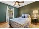 Calming bedroom with green walls features natural light and a queen size bed for peaceful relaxation at 3184 Maltby Dr, Deltona, FL 32738