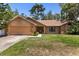 Charming single-story home featuring a brick facade, well-manicured lawn, and attached two-car garage at 3184 Maltby Dr, Deltona, FL 32738