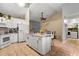 Well-appointed kitchen featuring white cabinets, granite countertops, and stainless steel appliances, plus a center island at 3184 Maltby Dr, Deltona, FL 32738