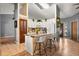 Bright, open kitchen featuring a center island with bar seating, white cabinetry, and modern appliances at 3184 Maltby Dr, Deltona, FL 32738
