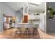 Bright kitchen featuring a granite island with barstool seating and modern white cabinetry at 3184 Maltby Dr, Deltona, FL 32738