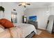 Comfortable bedroom features an ensuite and a TV at 3184 Maltby Dr, Deltona, FL 32738