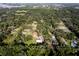 Aerial view of an established neighborhood where homes are nicely spaced and surrounded by mature trees at 3359 County Road 513, Wildwood, FL 34785