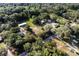 Aerial view highlighting the home's location surrounded by trees, and close to other houses with pools at 3359 County Road 513, Wildwood, FL 34785