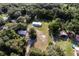 A charming home and separate garage are nestled amid lush greenery in this inviting aerial perspective at 3359 County Road 513, Wildwood, FL 34785