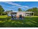 Backyard with a fire pit surrounded by chairs, providing an ideal spot for entertaining at 3359 County Road 513, Wildwood, FL 34785
