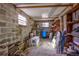 A basement with cinder block walls and shelves offers ample storage solutions and utility space for the home at 3359 County Road 513, Wildwood, FL 34785