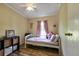 Cozy bedroom features purple accents, a ceiling fan, and a storage unit at 3359 County Road 513, Wildwood, FL 34785