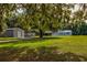 Wide shot showing the home, garage and other outbuildings situated on a large lot at 3359 County Road 513, Wildwood, FL 34785