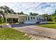 Charming single-story home with a covered carport, well-manicured lawn, and an American flag at 3359 County Road 513, Wildwood, FL 34785