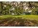 Expansive front yard featuring mature trees and a residence set back from the road at 3359 County Road 513, Wildwood, FL 34785