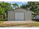 Large metal building garage with a roll-up door and ample storage space at 3359 County Road 513, Wildwood, FL 34785