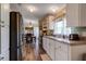 Bright kitchen featuring white cabinets and stainless-steel appliances at 3359 County Road 513, Wildwood, FL 34785