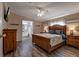 Spacious main bedroom suite with a large bed frame, ceiling fan, and attached bathroom at 3359 County Road 513, Wildwood, FL 34785