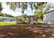 View of multiple utilitarian outbuildings with metal and concrete block construction on wooded lot at 3359 County Road 513, Wildwood, FL 34785