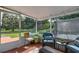Relaxing sunroom with comfortable seating and views of the surrounding backyard at 3359 County Road 513, Wildwood, FL 34785