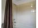 Clean bathroom featuring tiled walls, a bathtub with shower head, a neutral color scheme, and a shower curtain at 37007 Forestdel Dr, Eustis, FL 32736