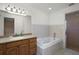 Serene bathroom featuring a soaking tub, shower, and vanity for relaxing self-care at 37007 Forestdel Dr, Eustis, FL 32736